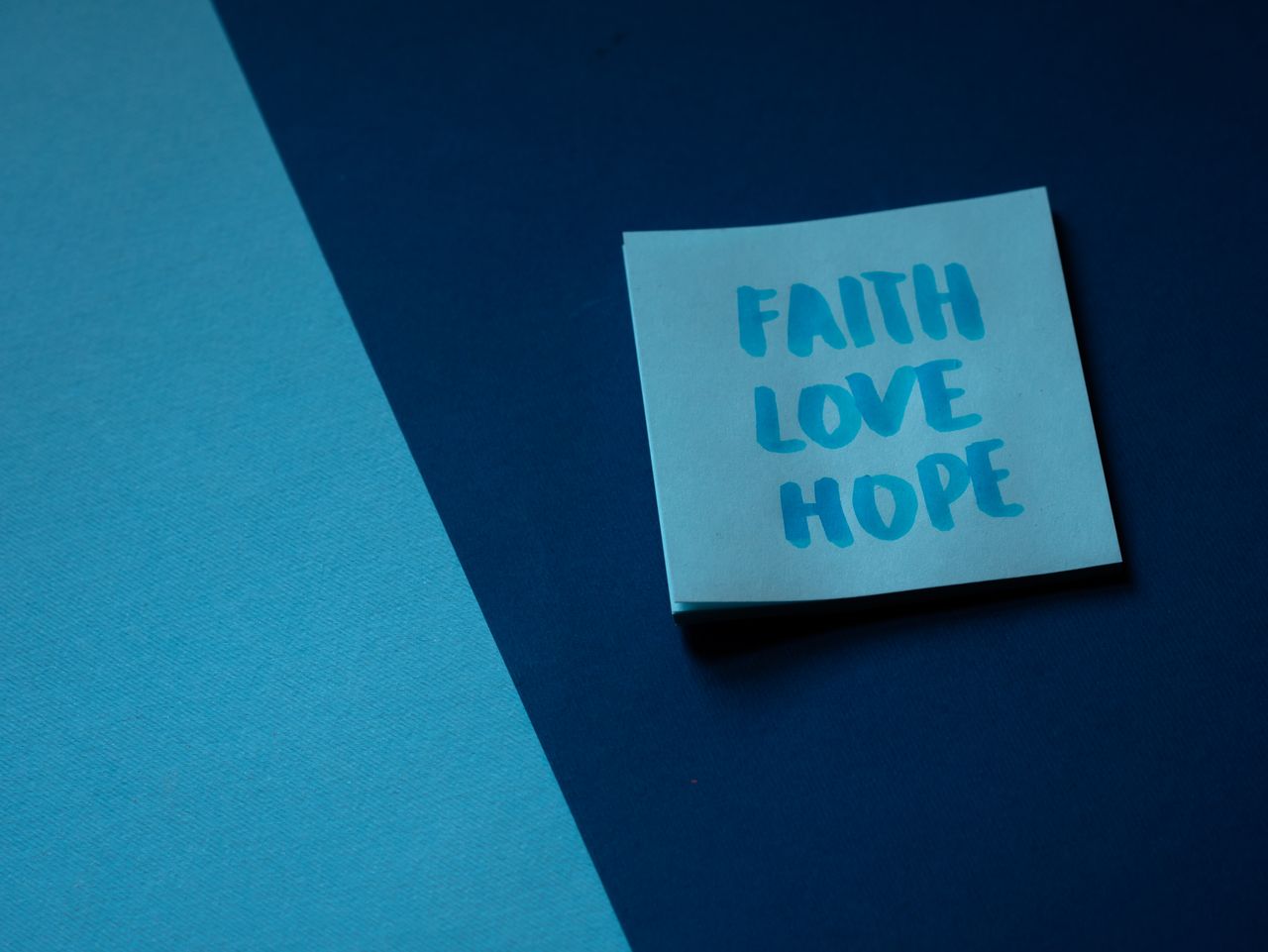 Services A blue note on contrasting backgrounds displaying the words faith, love, and hope.